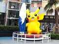 Statue of Surfing Pikachu outside the store.